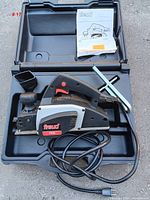 Electric planer Freud FE82 in carrying case with power cord and guide fence attachment, showing general condition and included accessories.