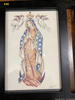 Framed postcard of Madonna figure with cherubs in tattoo style