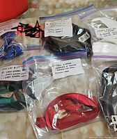 Photo showing multiple labeled zipper bags including purple zipper, dark green zippers, red two-way zippers with metal stops, and other specialty zipper bags.