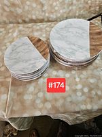 Two stacks of plates; one stack smaller (sandwich size), one larger (dinner size). Both plates have half marble pattern and half wood grain pattern.