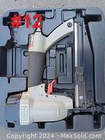 Porter Cable brad nailer inside molded black plastic carrying case showing tool body and grip closeup.