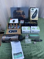Full lot overview with Prophet tattoo kit, grooming clipper, boxed items, and soap toiletries.