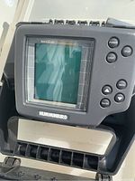 Close-up of the Humminbird Wide Range Fish Finder display and control buttons in its case.