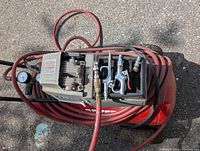 Top view showing oil-free pump, air hose and pneumatic tool attachments coiled on compressor tank