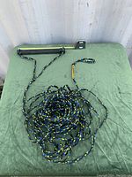 Tow rope coiled with mounted metal mounting bar showing bracket on one side