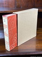 Photo of the hardcover stamp album in slipcase with red and white decorative spine label indicating date range 94/71 - 1968