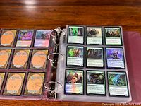 Open binder with two clear plastic pages containing Magic: The Gathering cards.