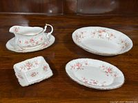 Full set including two oval serving dishes, gravy boat with under plate, square trinket dish, and the salt and pepper shakers.