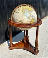 Full view of the vintage 16 inch Replogle globe on maple stand depicting continents including North America and South America.