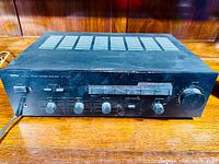 Front perspective of Yamaha AX-400U amplifier showing overall unit and control panel.