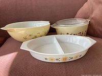 Three Pyrex casserole dishes arranged showing variety of patterns and shapes