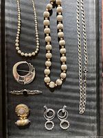 Overview of all jewelry items laid out on black background