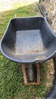 View of the black plastic bucket of the wheelbarrow