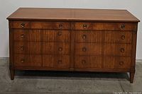 Front view of the eight drawer chest showing the wood grain and drawer pull detail.