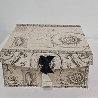 Closed decorative fabric box with black bow, vintage design