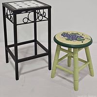 Front angle of both items showing tile top plant stand and grape painted stool