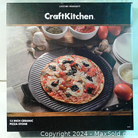 Box showing 13 inch CraftKitchen ceramic pizza stone on a round pizza on table with mushrooms and seasonings.