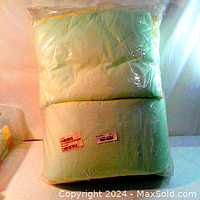 Plastic-wrapped reversible toddler bedding comforter, mint side facing out, showing stitching and soft plush fabric.