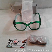 Glasses displayed with original packaging box, protective white bag, thank you card and sealed accessory pouch.