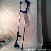 Full view of the pair of aluminum forearm crutches with blue grips and no-slip feet, displayed against a white backdrop.