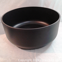 Photo of the smooth matte black round planter bowl showing outer surface and shape.