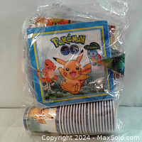 Sealed package showing Pokemon Go napkins and cups with popular characters Pikachu, Charmander, and Squirtle.