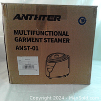 Closed cardboard box with ANTHITER logo and product name 'MULTIFUNCTIONAL GARMENT STEAMER ANST-01' printed on the front