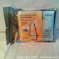 Top view showing sealed facial mask packets in holographic pouch with visible Hyaluronic Acid Facial Mask packet