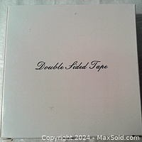White box with black script reading 'Double Sided Tape' for product packaging