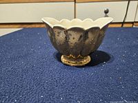 Overall view of footed scalloped bowl showing gold exterior wear