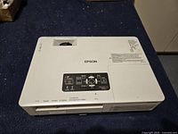 Top view of Epson EMP-1705 projector showing lens aperture and control panel