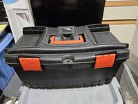 Closed black toolbox front view showing red latches