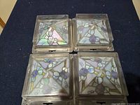 Top view of four stained glass post caps