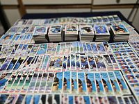 Wide view of large spread of 1982 Topps cards laid out plus several stacked piles