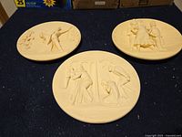Front view showing relief scenes on three ivory alabaster plates