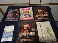 Overall view showing six main printed items on tabletop