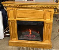Full view of the Classic Flame faux fireplace with heater, oak wood finish with realistic flame effect and decorative molding.
