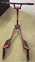 Front view of red and black Yvolution Fliker Lift Drift scooter showing dual front platforms and handlebars.