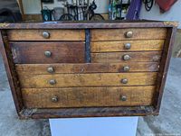 Front view showing eight drawers and brass knobs
