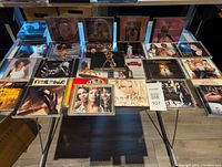 Table display of first set of approximately 18 CDs including Christina Aguilera, Mariah Carey, Celine Dion, Whitney Houston, Shakira, Britney Spears, Janet Jackson among others