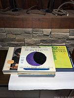 Stack of LP records including Beethoven Centennial Collection and Far Away Places stereo 35 mm album, showing album covers and titles.