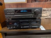 Front view of Technics receiver on top and JVC dual cassette tape deck below, showing display and control buttons.