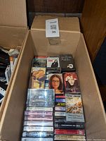 Box showing stacked commercial tape cassettes with full album covers visible on top