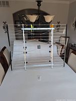 Front view of Channel Master CM-4228HD HDTV antenna showing rectangular metal frame with multiple aluminum antenna elements, black mounting hardware, and attached amplifier.