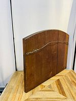 Back view of the wooden framed mirror showing hanging wire and wood panel construction.