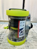 Front and side view of the Hoover vacuum showing clear dust canister with lime green accents and handle on top.