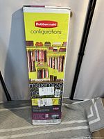 Full view of the Rubbermaid Configurations closet kit box showing brand, product line, and an illustration of the adjustable closet system setup to maximize space.