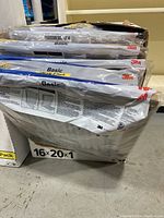 Stack of new 3M Filtrete Basic air filters in original packaging, showing 16x20x1 size.