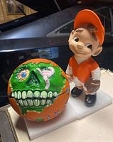 Photo showing both the Super Madballs basketball and baseball player figurine together for scale and comparison.