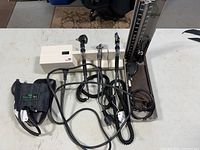 Overall view of vintage Welch Allyn medical diagnostic equipment with heads, cords, and mercury sphygmomanometer